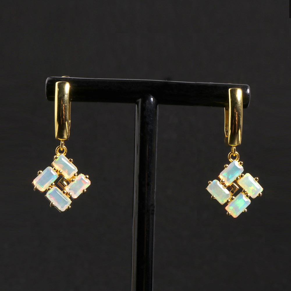 ‘Phoenix’ Baguette Opal Pinwheel Drop Earrings – on display stand