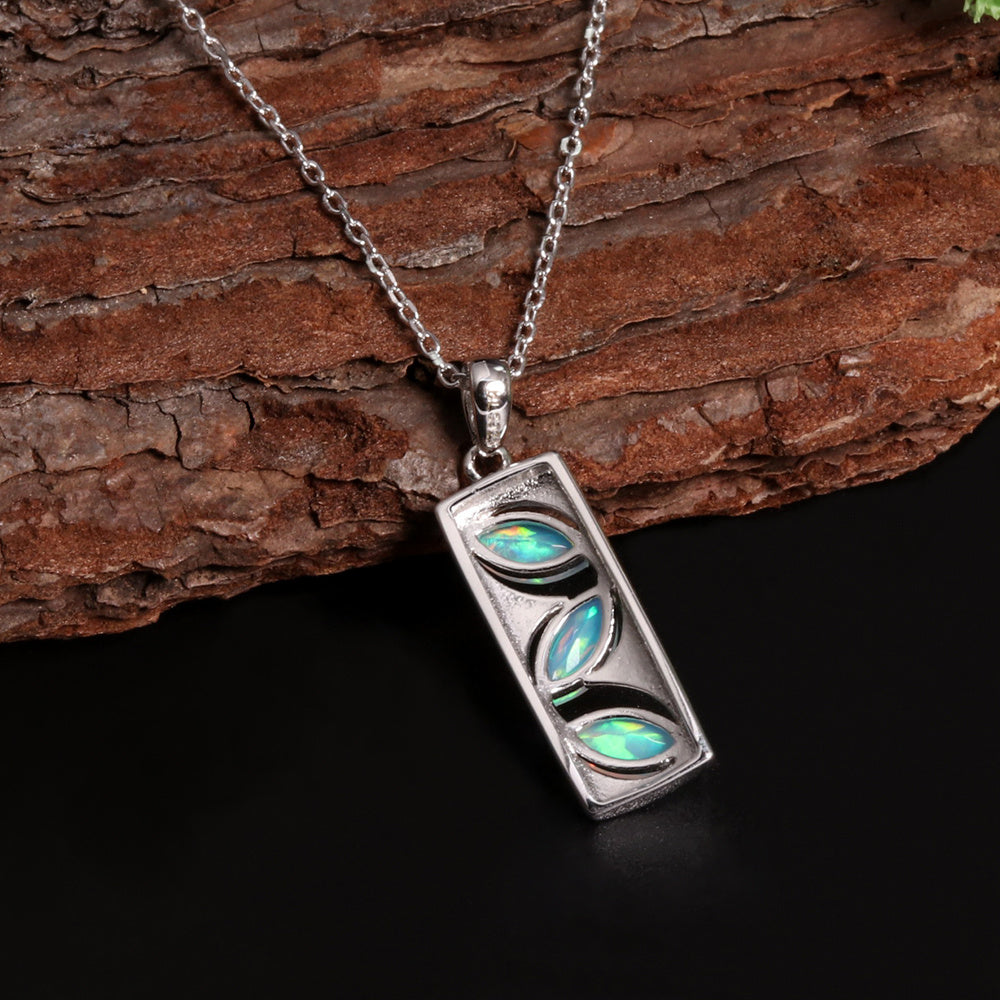 ‘Elodie’ Marquise Opal Bar Pendant – angled on wood