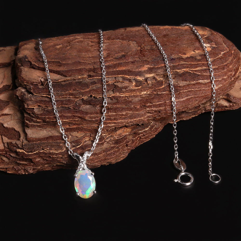 ‘Mercy’ Oval Opal Cross Bail Pendant – draped on wood