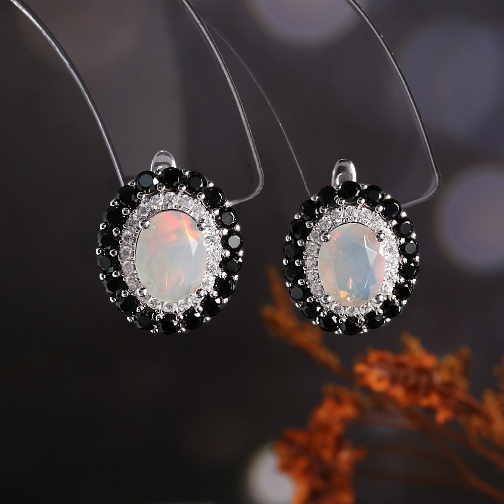 ‘Edith’ Oval Opal Double Halo Earrings (7 × 9 mm) – hanging view