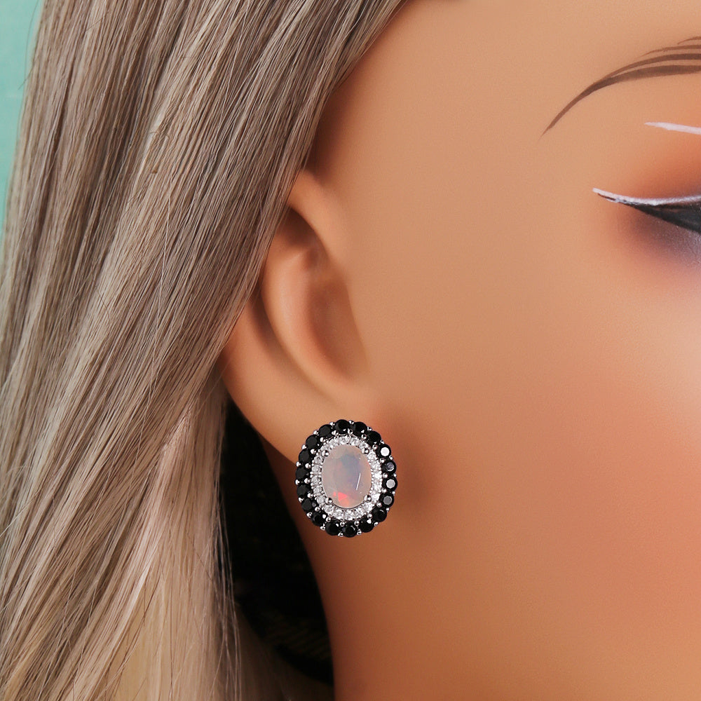 ‘Edith’ Oval Opal Double Halo Earrings (7 × 9 mm) – on ear