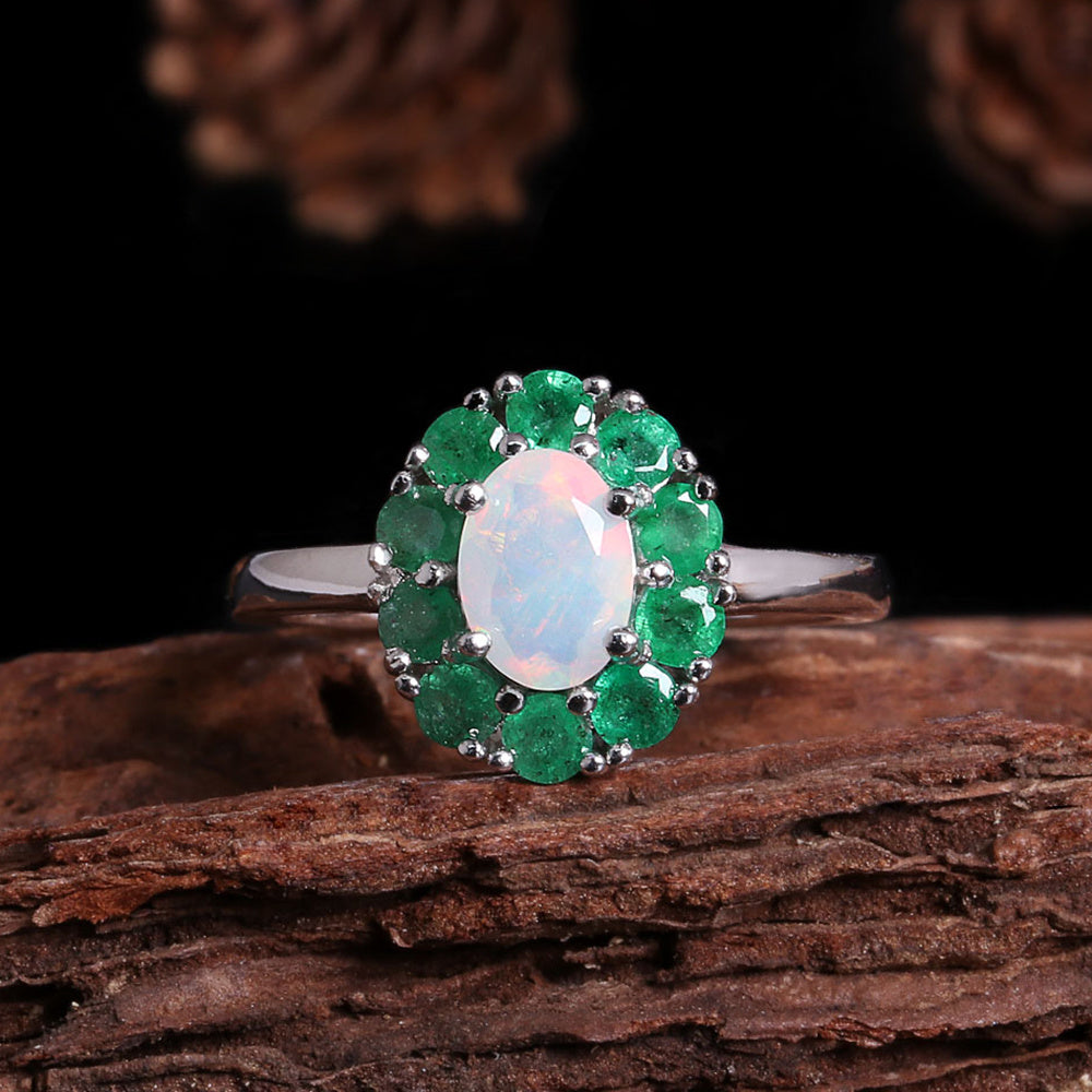 ‘Emmeline’ Oval Opal Emerald Halo Ring – on wood