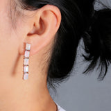 ‘Savannah’ Baguette Opal Line Drop Earrings – on ear