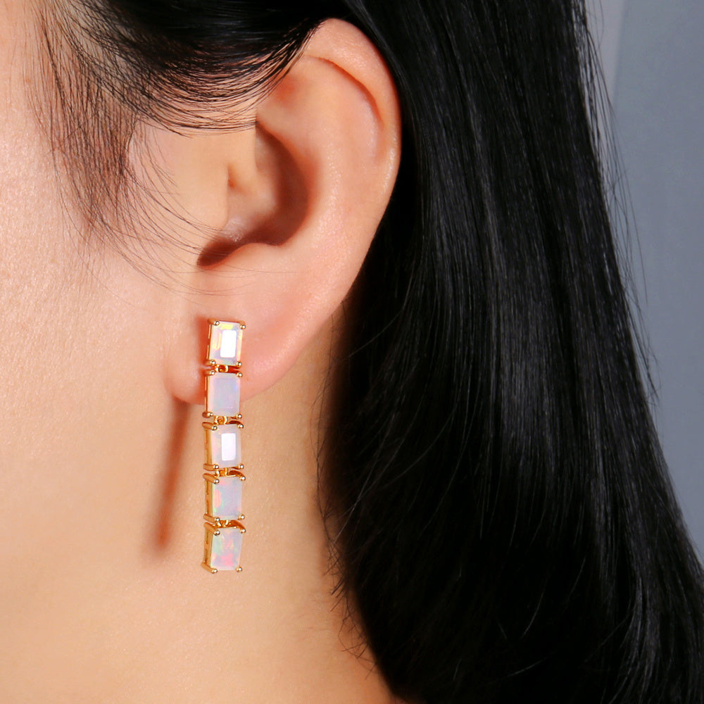 ‘Savannah’ Baguette Opal Line Drop Earrings – yellow on ear