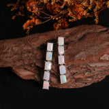 ‘Savannah’ Baguette Opal Line Drop Earrings – white on wood