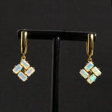 ‘Phoenix’ Baguette Opal Pinwheel Drop Earrings – on display stand