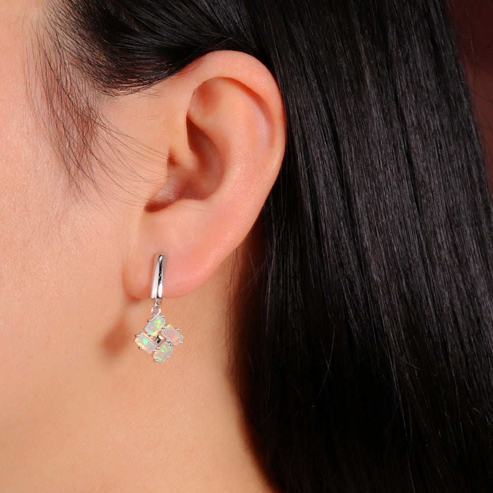 ‘Phoenix’ Baguette Opal Pinwheel Drop Earrings – on ear