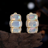 ‘Lottie’ Cushion Opal Three Stone Set – earrings on driftwood