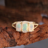 ‘Lottie’ Cushion Opal Three Stone Set – ring on driftwood