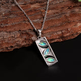 ‘Elodie’ Marquise Opal Bar Pendant – angled on wood