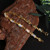 ‘Melrose’ Marquise Opal Cross Link Bracelet – on wood gold