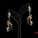 ‘Tamsin’ Mermaid Pear Opal Drop Earrings – on display stand