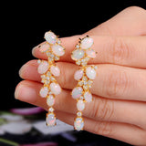 ‘Adelaide’ Opal Cluster Cascade Drop Earrings – held on fingers