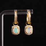 ‘Birdie’ Opal Halo Charm Huggie Earrings – on display stand