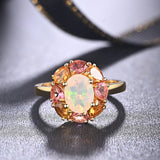 ‘Freesia’ Opal Tourmaline Flower Halo Ring – front on fabric