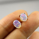 ‘Robin’ Oval Faceted Opal Stud Earrings – on fingertip