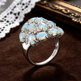 ‘Leigh’ Oval Opal Cluster Cocktail Ring – angled on lace
