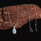 ‘Mercy’ Oval Opal Cross Bail Pendant – draped on wood