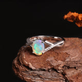 ‘Blythe’ Oval Opal Crossover Solitaire Ring – on wood