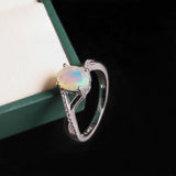 ‘Blythe’ Oval Opal Crossover Solitaire Ring – on green box
