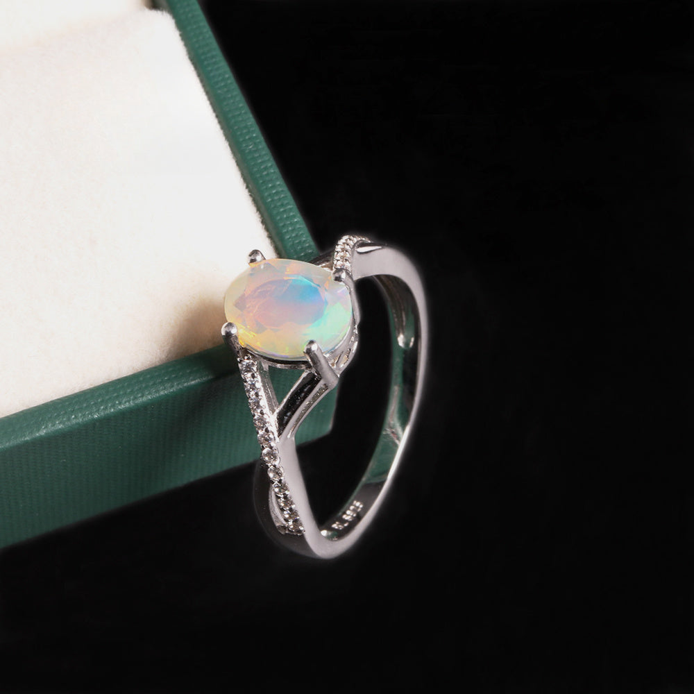 ‘Blythe’ Oval Opal Crossover Solitaire Ring – on green box
