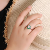 ‘Sylvie’ Oval Opal Emerald Halo Set – ring on hand