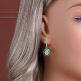 ‘Sylvie’ Oval Opal Emerald Halo Set – earring on ear