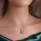 ‘Sylvie’ Oval Opal Emerald Halo Set – pendant on neck