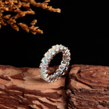 ‘Everly’ Oval Opal Eternity Band Ring – upright on wood