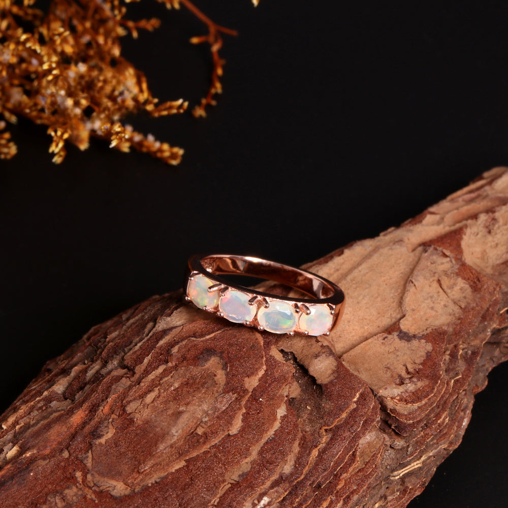 ‘Peony’ Oval Opal Half Eternity Ring – on wood
