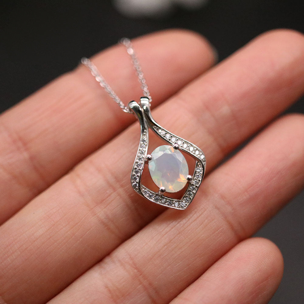‘Lark’ Oval Opal Kite Frame Pendant – held in hand