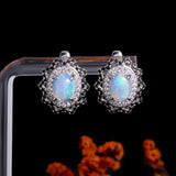 ‘Neve’ Oval Opal Starburst Halo Earrings – on display stand