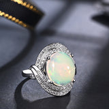 ‘Cove’ Oval Opal Swirl Halo Ring – angle view