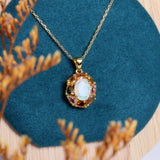 ‘Carmel’ Oval Opal Tourmaline Halo Pendant – styled on velvet