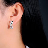 ‘Tessa’ Oval Opal X Cross Earrings – on ear