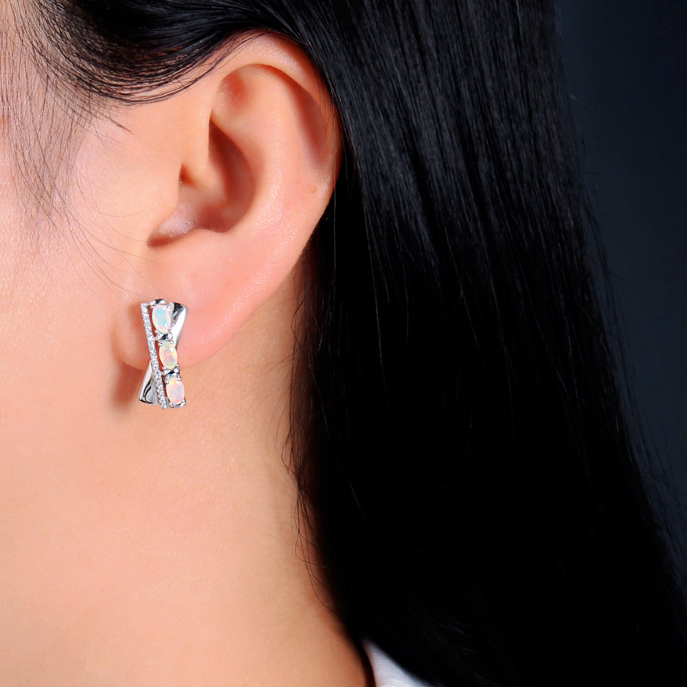 ‘Tessa’ Oval Opal X Cross Earrings – on ear