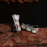 ‘Tessa’ Oval Opal X Cross Earrings – on wood side
