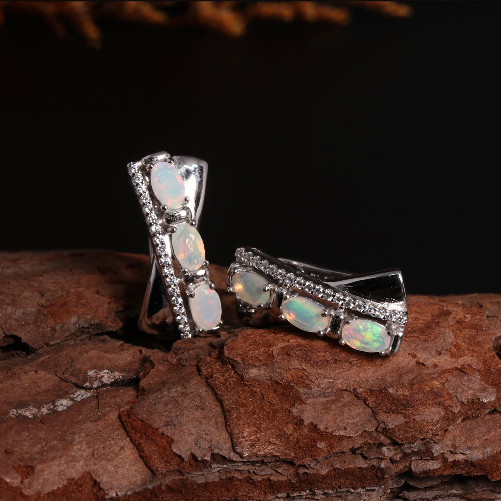 ‘Tessa’ Oval Opal X Cross Earrings – on wood side
