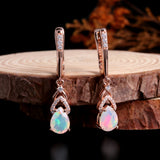 ‘Rose’ Pear Opal Chevron Drop Earrings – on wood slice