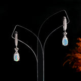 ‘Ainsley’ Pear Opal Crossover Drop Earrings – on display stand