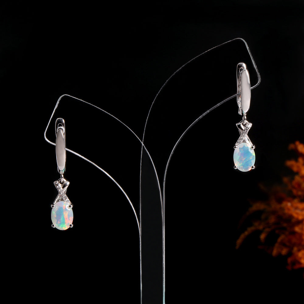 ‘Ainsley’ Pear Opal Crossover Drop Earrings – on display stand
