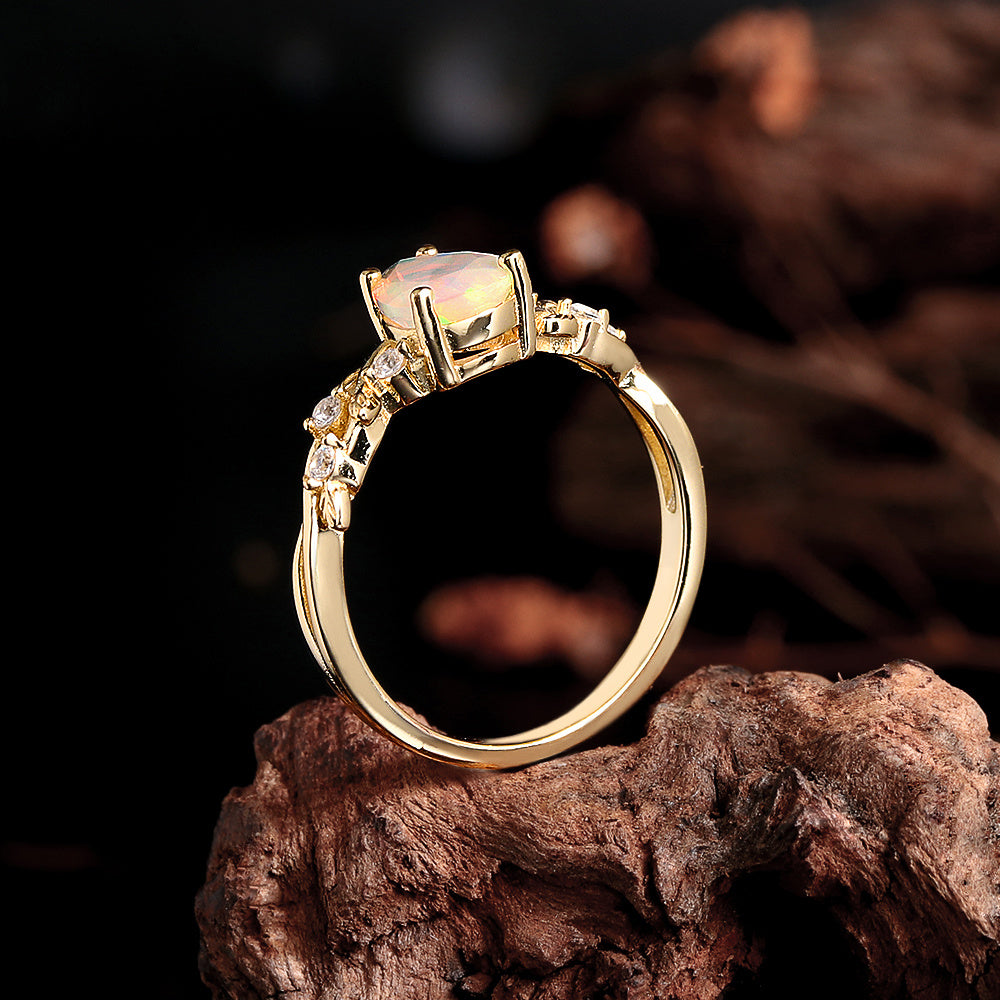 ‘Ivy’ Pear Opal Leaf Vine Ring – standing on wood