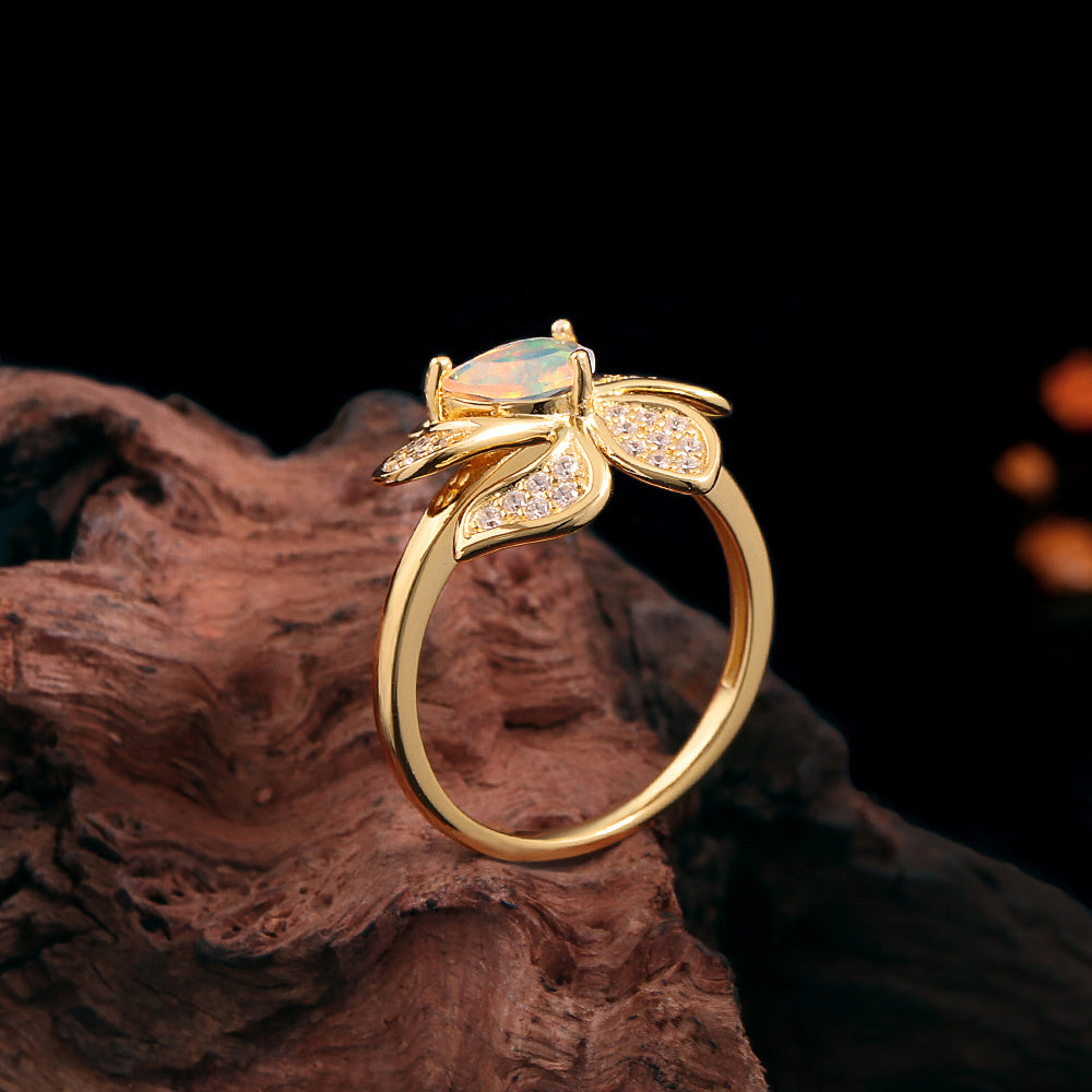 ‘Rosella’ Pear Opal Pave Flower Ring – upright on wood