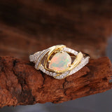 ‘Paisley’ Pear Opal Swirl Halo Set – ring on wood