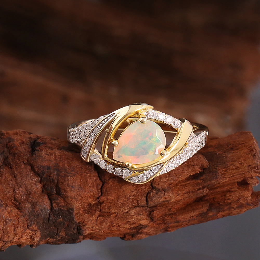 ‘Paisley’ Pear Opal Swirl Halo Set – ring on wood