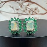 ‘Glory’ Rectangle Opal Emerald Halo Earrings – front with blossom