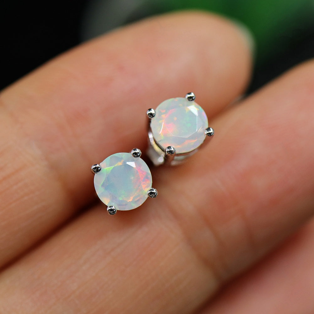 ‘Meg’ Round Faceted Opal Stud Earrings – on fingertip