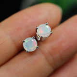 ‘May’ Round Faceted Opal Stud Earrings – on fingertips