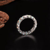 ‘June’ Round Opal Eternity Band Ring – upright on wood