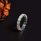 ‘June’ Round Opal Eternity Band Ring – angle with flowers